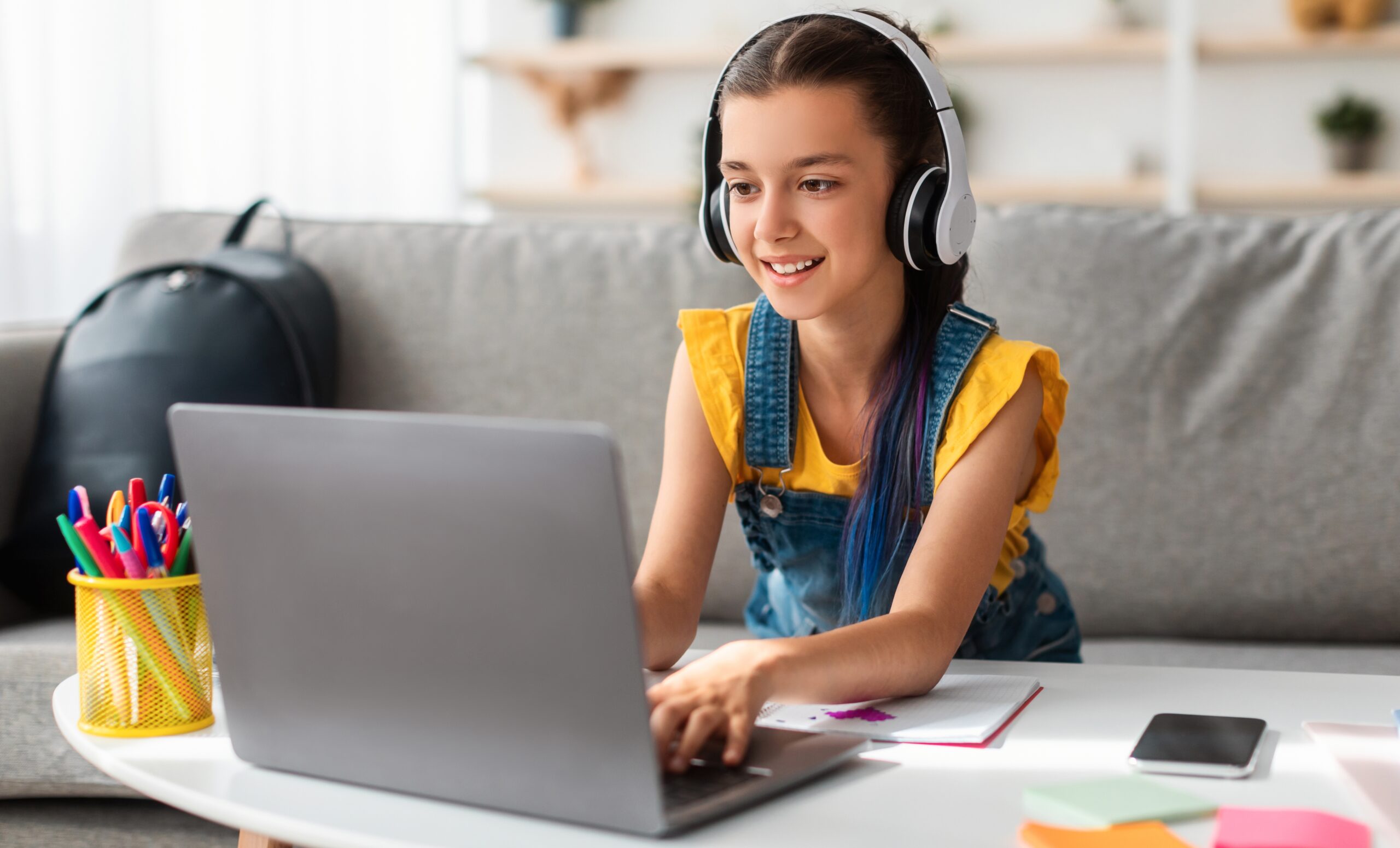 Portrait,Of,Little,Girl,In,Wireless,Headset,Using,Laptop,,Studying